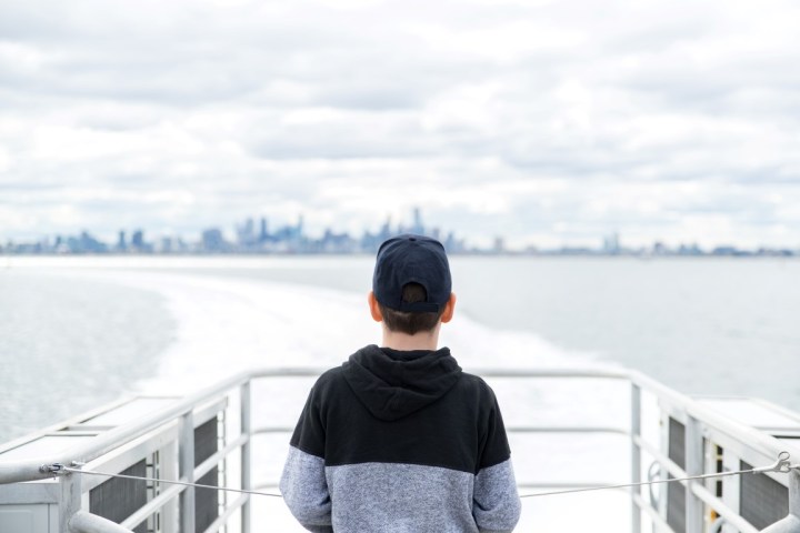a person standing next to a body of water