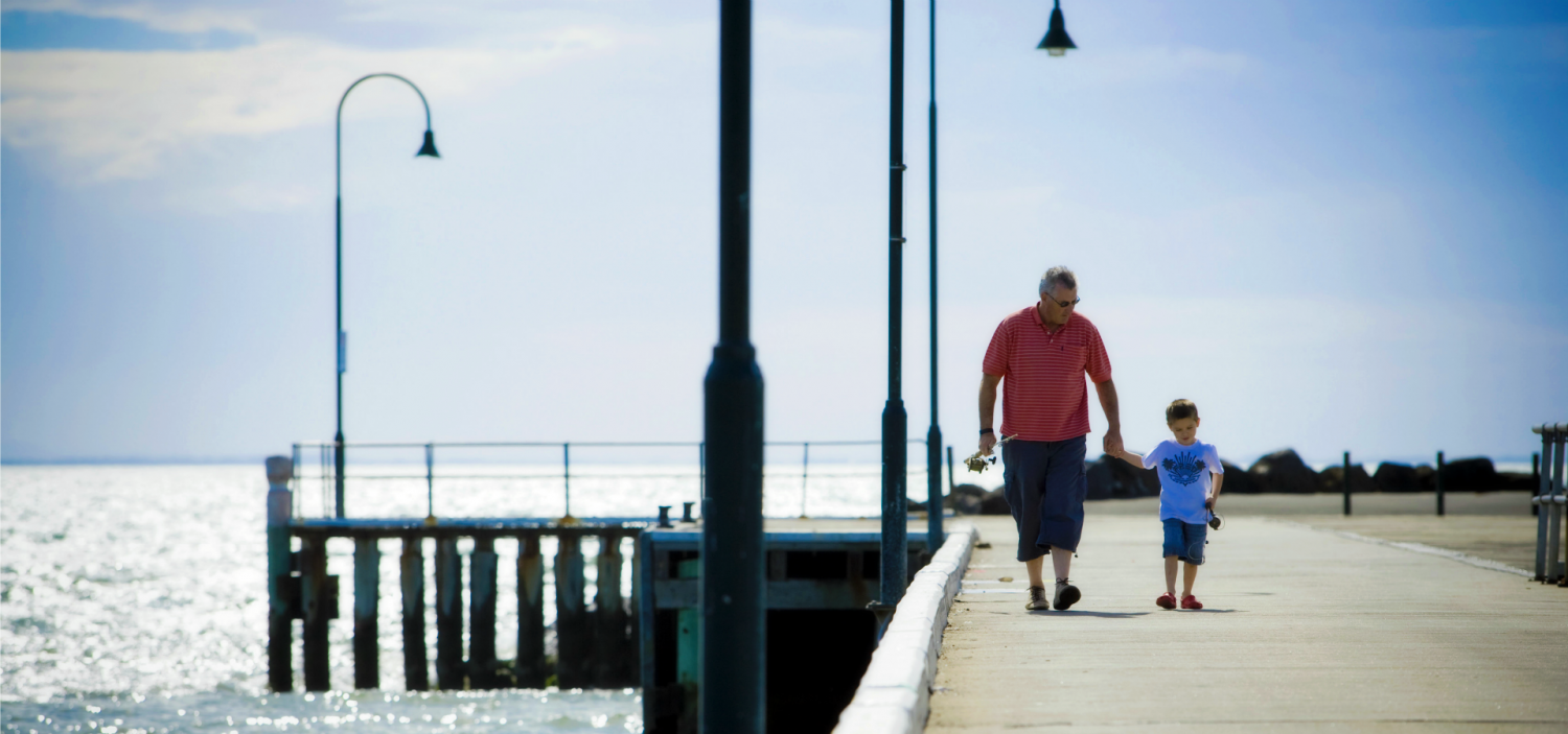 a man standing next to a body of water