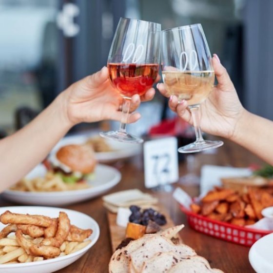 a woman sitting at a table with a plate of food