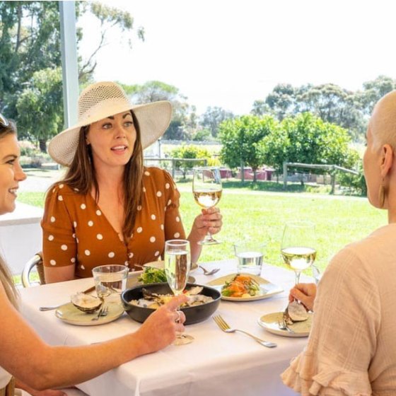 a group of people sitting at a table eating food