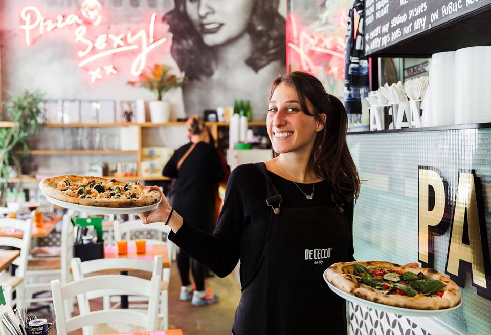 a woman sitting at a table with food