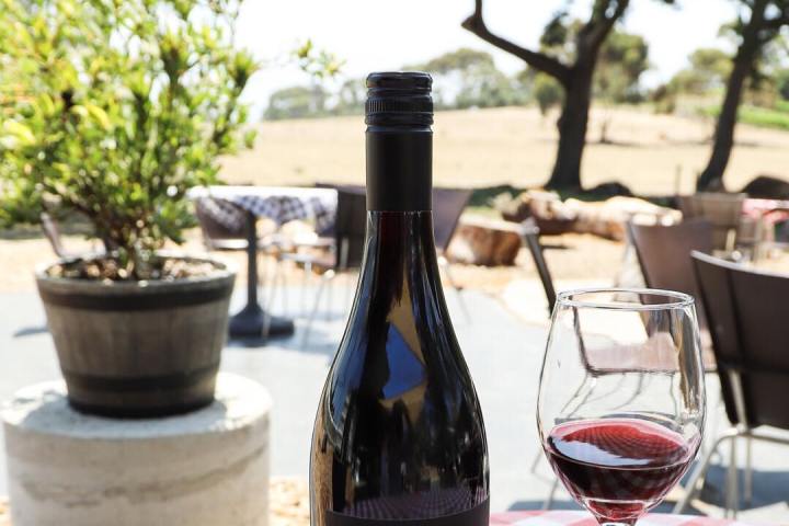 a bottle of wine and a glass of beer on a table