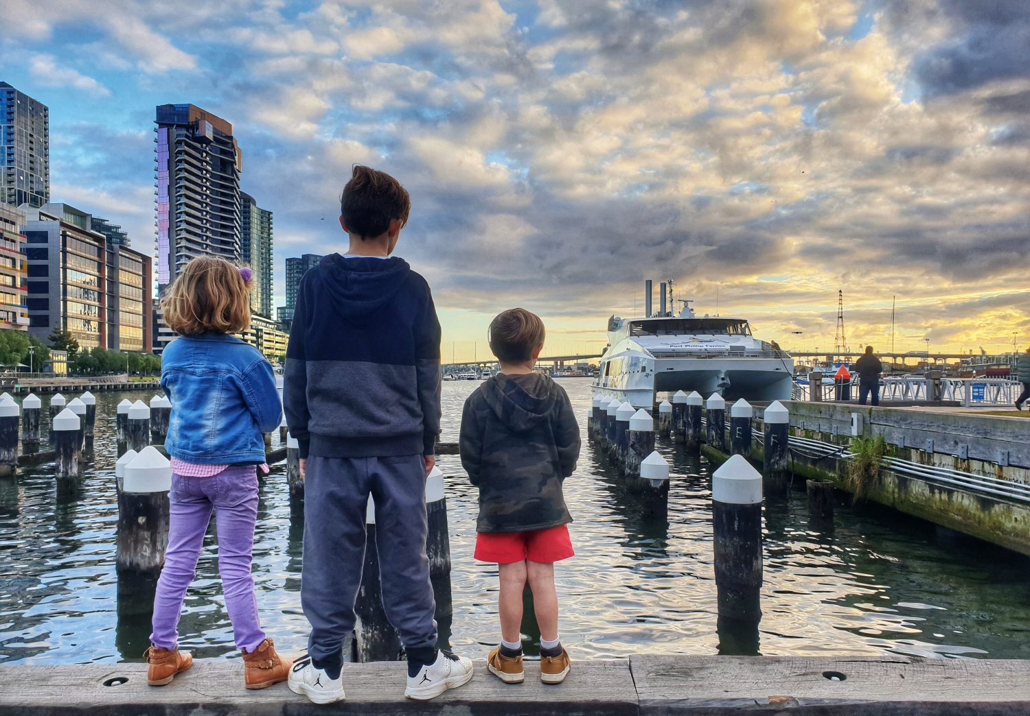 a group of people standing next to a river