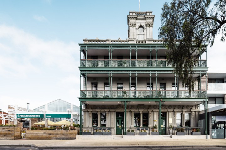 Victorian-style building with ornate balconies and a tall central tower.
