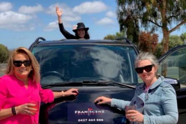 a man and a woman standing next to a car