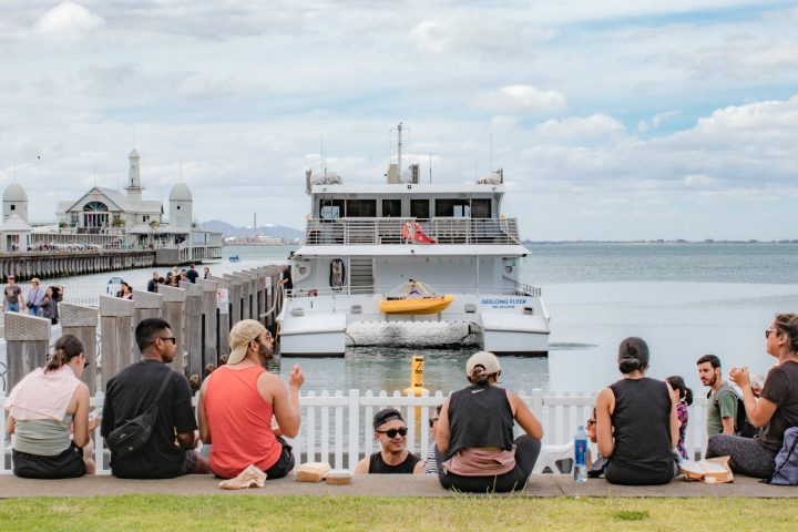 a group of people standing in front of a body of water