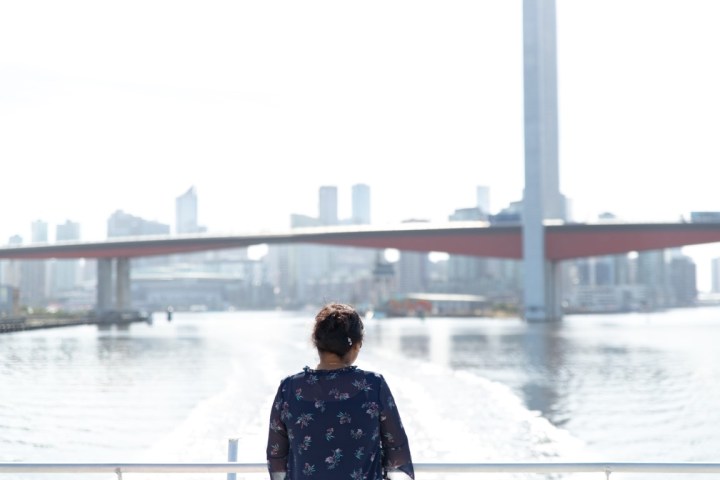 a man standing in front of water