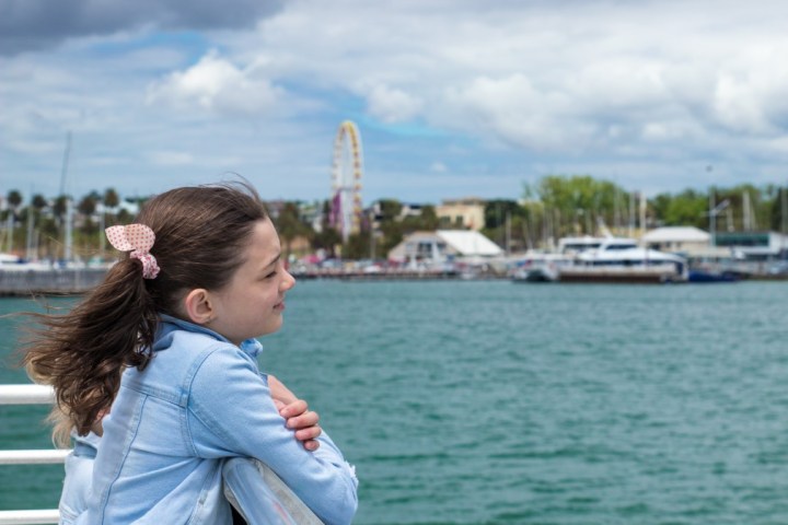 a person standing next to a body of water