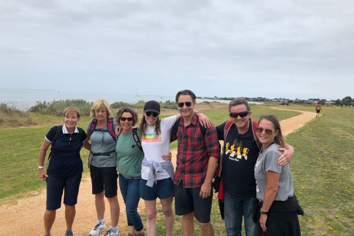 a group of people standing in a field posing for the camera
