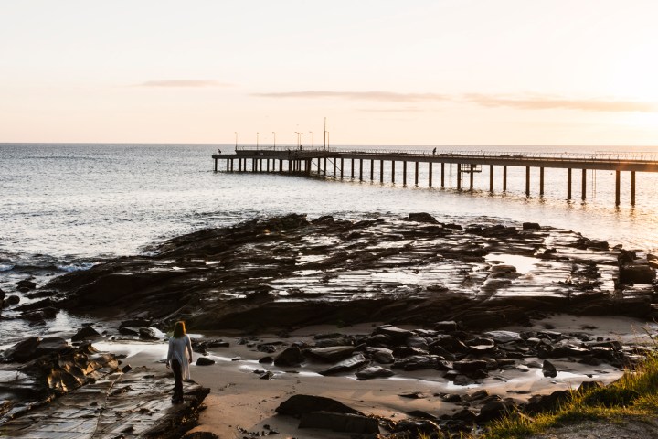 a close up of a pier next to a body of water