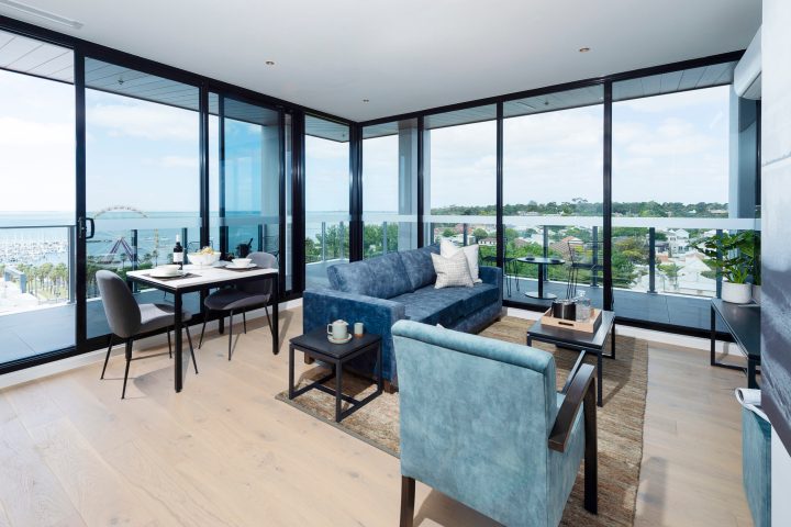 a living room filled with furniture and a large window