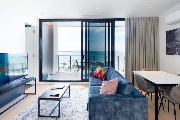 a living room filled with furniture and a large window