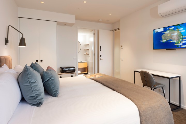 a bedroom with a large bed in a hotel room