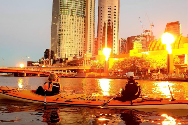 a boat in the water with a city in the background