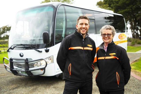 a man standing next to a bus