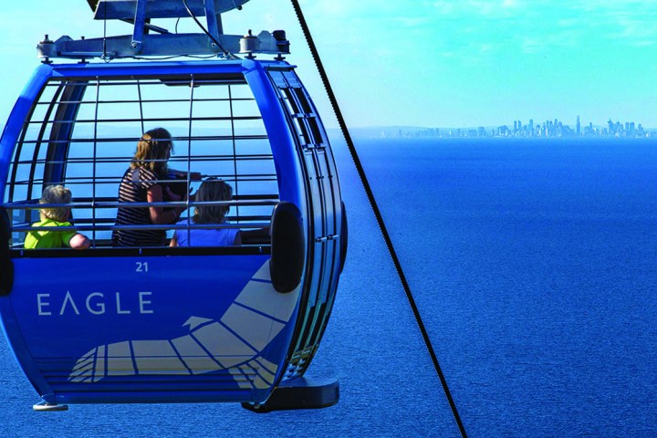 a blue and white boat sitting next to a body of water