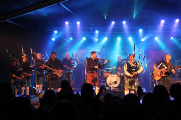 a group of people on a stage in front of a crowd