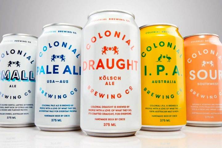 a bottle next to a cup of coffee