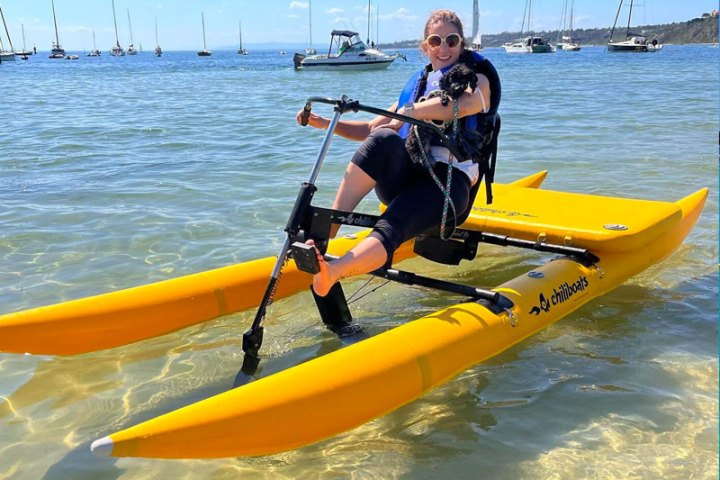 a man riding on the back of a boat in a body of water