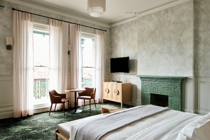 a bedroom with a large bed in a hotel room