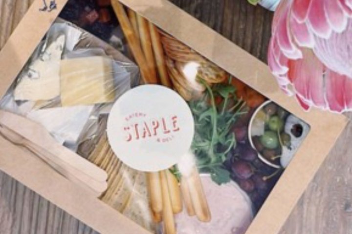a vase of flowers sitting on top of a wooden table