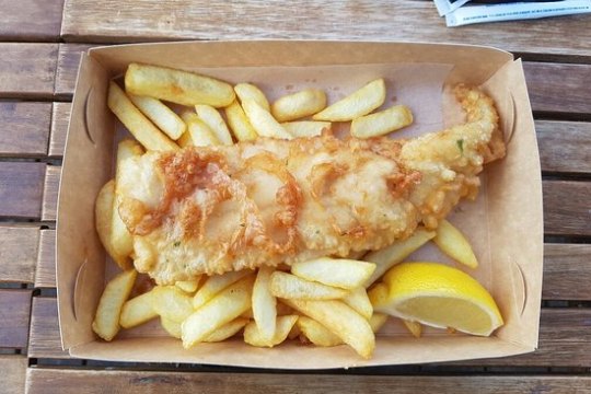 a sandwich sitting on top of a wooden cutting board