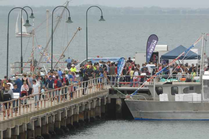a group of people on a boat in a large body of water