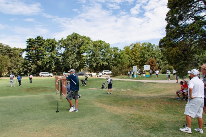 a group of people playing frisbee in a park