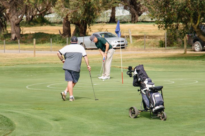 a group of people playing a game of frisbee in a park