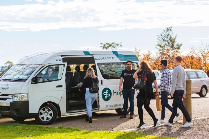 a group of people standing in front of a car