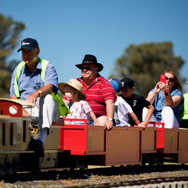 a group of people riding on the back of a train