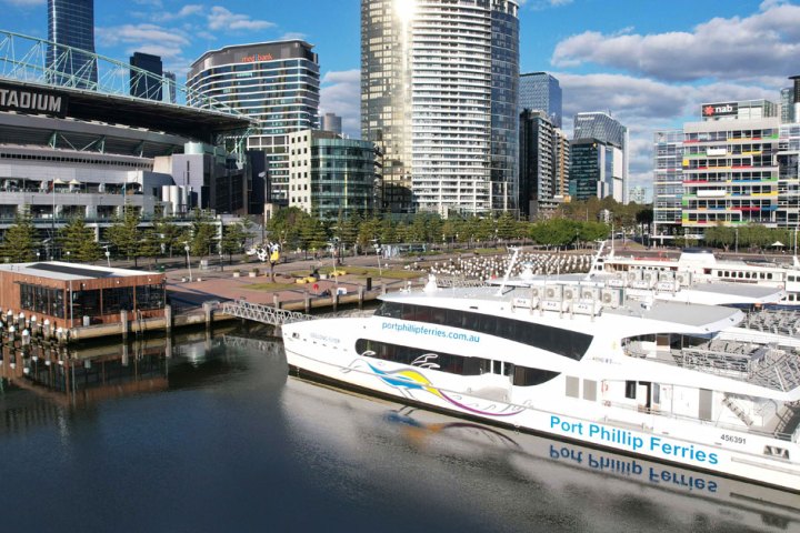 a small boat in a body of water with a city in the background