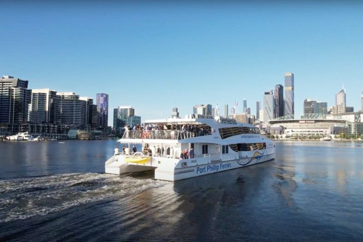a small boat in a body of water with a city in the background