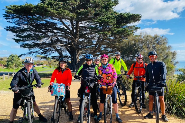 a group of people riding on the back of a bicycle