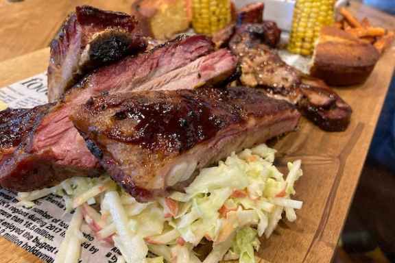 a sandwich sitting on top of a wooden cutting board