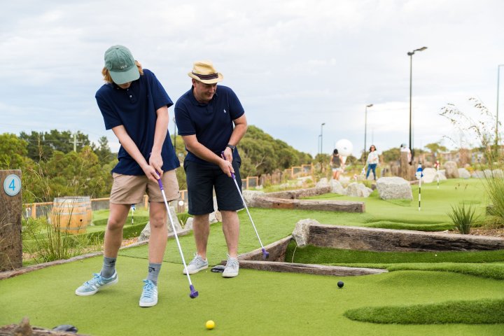 a man holding a golf club