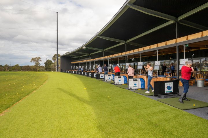 a group of people that are standing in the grass