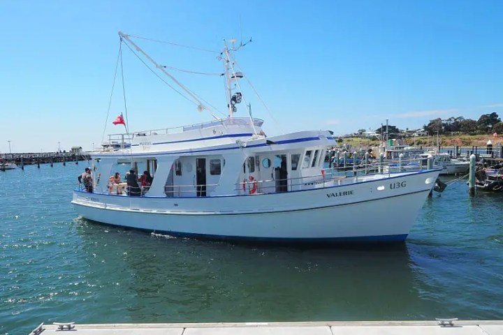 a boat is docked next to a body of water