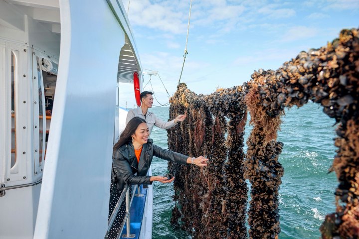 a man standing next to a body of water