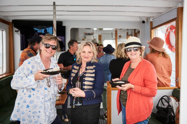 a group of people holding wine glasses