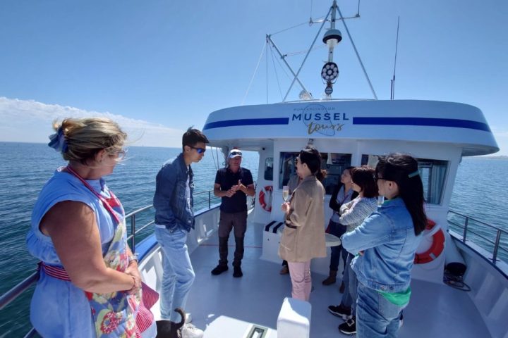 a group of people standing on a boat