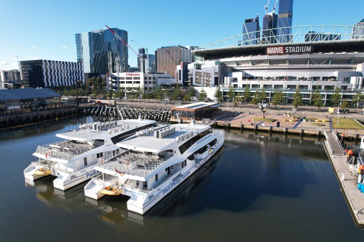 a small boat in a body of water with a city in the background