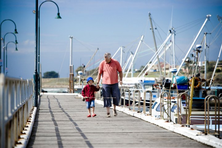 a group of people walking on a bridge