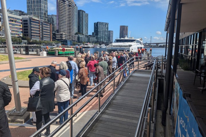 a group of people walking on a bridge