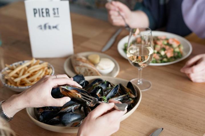 a group of people sitting at a table with a plate of food