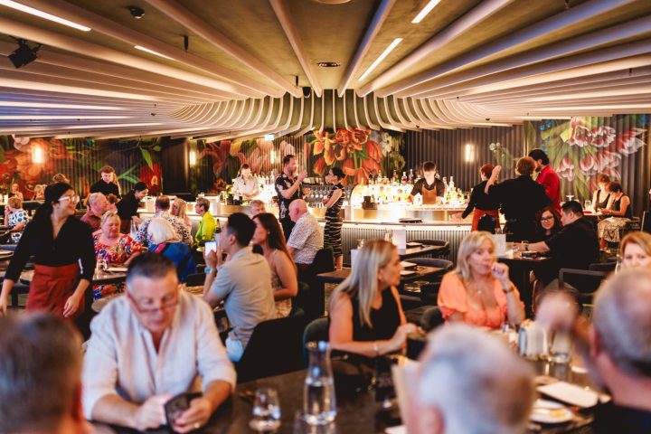a group of people sitting at a table with wine glasses