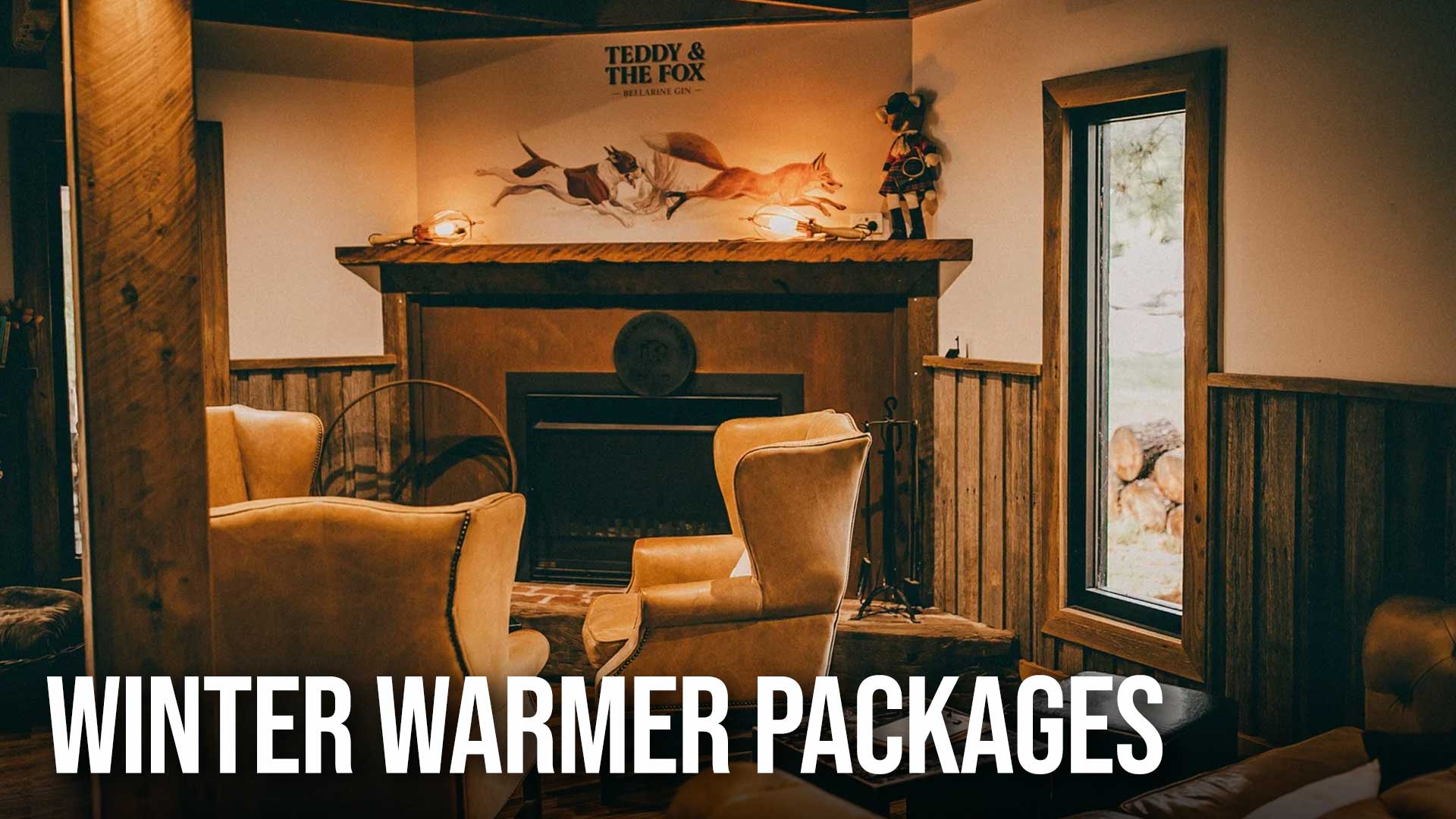 Cozy room with fireplace, armchairs, and a 'Winter Warmer Packages' sign.