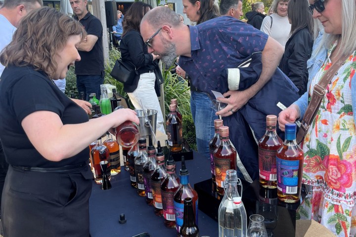 People sampling various wines at an outdoor event.